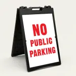 No Public Parking sign black text on yellow background