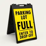 Parking Lot Full Enter to Drop-Off sign with black text on yellow background