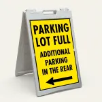 Parking Lot Full Additional Parking in the Rear sign with left arrow on yellow background