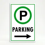 Parking sign with green circle P symbol and left-pointing arrow on white background