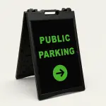 Public Parking sign with green text and right-pointing arrow on black background