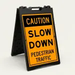 Caution Slow Down Pedestrian Traffic sign with bold black text on orange background
