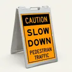 Caution Slow Down Pedestrian Traffic sign with bold black text on orange background