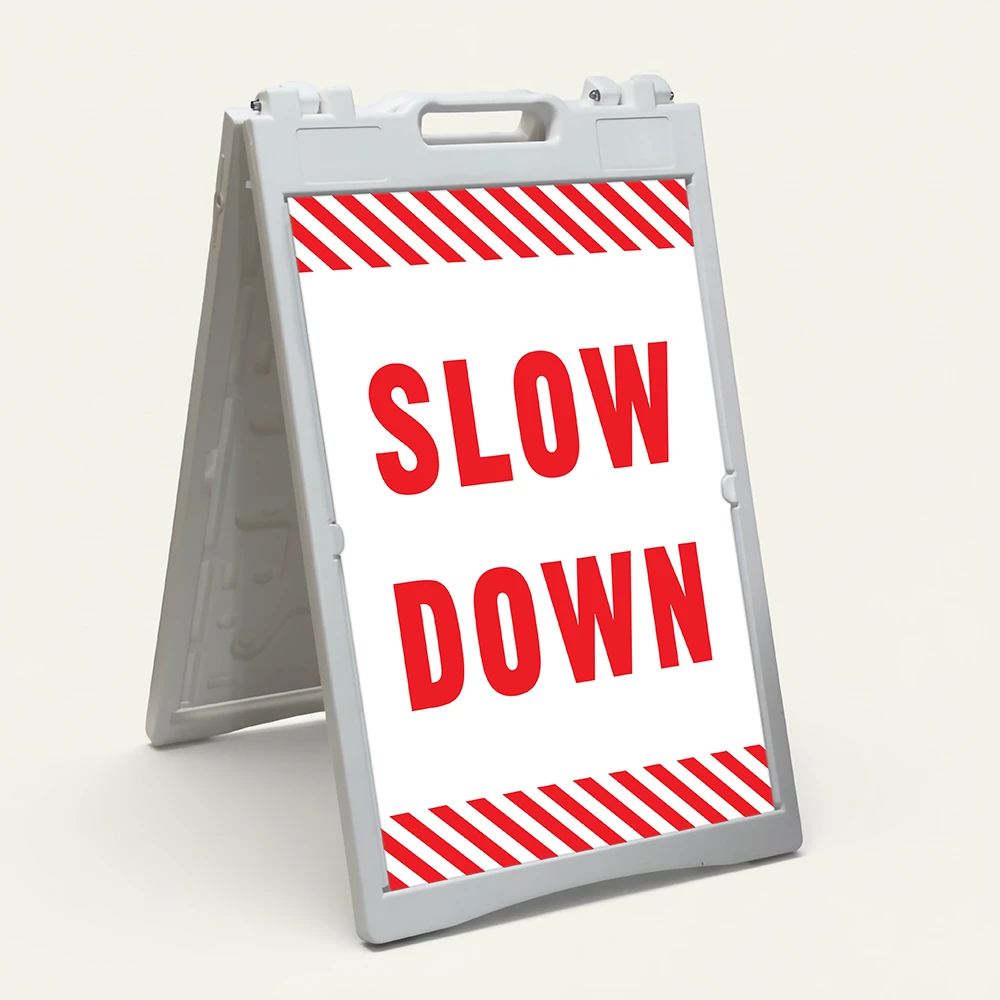 Slow Down sign with red text on white background and diagonal red and white hazard stripes