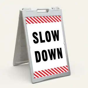 Slow Down sign with black text on white background and diagonal red and white hazard stripes