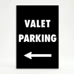 Valet Parking sign with bold white text and left-pointing arrow on black background