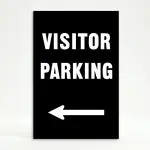 Visitor Parking sign with bold white text and left-pointing arrow on black background