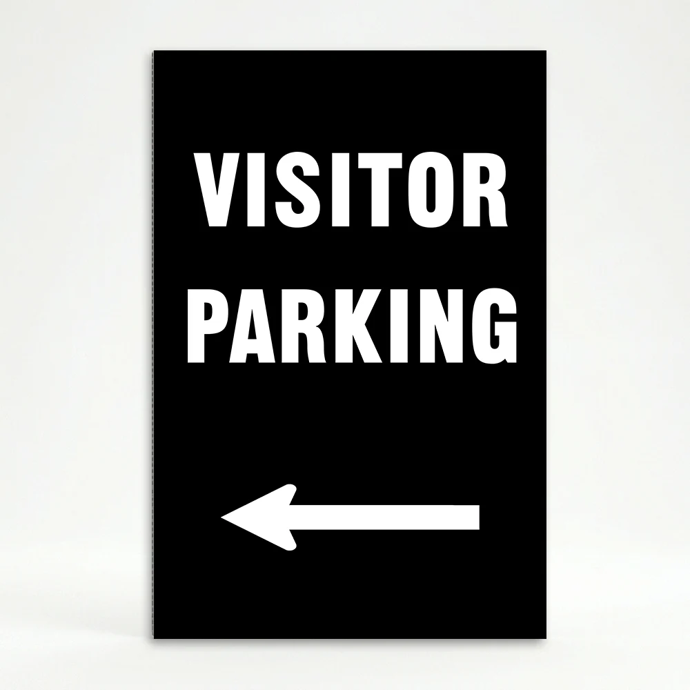 Visitor Parking sign with bold white text and left-pointing arrow on black background