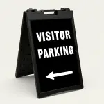 Visitor Parking sign with bold white text and left-pointing arrow on black background