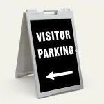 Visitor Parking sign with bold white text and left-pointing arrow on black background