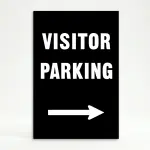 Visitor Parking sign with bold white text and right-pointing arrow on black background
