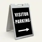 Visitor Parking sign with bold white text and right-pointing arrow on black background