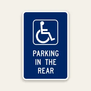 Handicap parking in the rear sign with ADA symbol directing drivers to rear parking area