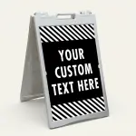 Custom text hazard stripe A-frame sign with black panel and white diagonal stripes in white frame for Los Angeles business or property
