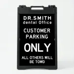 Custom tow warning parking enforcement A-frame sign with black background and white text for Los Angeles retail store apartment or office building