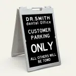 Custom tow warning parking enforcement A-frame sign with black background and white text for Los Angeles retail store apartment or office building