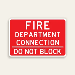 Full red 18x12 horizontal Maxmetal sign with bold white FIRE DEPARTMENT CONNECTION text across three lines in upper zone, white horizontal dividing line, and bold white DO NOT BLOCK text in lower zone, no border.