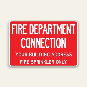 Custom fire department connection sign with red background and white text showing building address and fire sprinkler only designation for Los Angeles commercial building