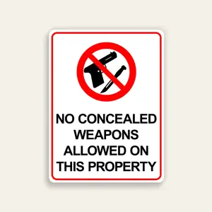 White and red 18x24 vertical Maxmetal sign with red circle-slash over gun and knife icons and bold black text reading No Concealed Weapons Allowed On This Property, mounted at building entrance in Los Angeles.