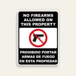 Full black 18x24 vertical Maxmetal sign with bold white English text No Firearms Allowed On This Property at top, white-bordered inset with red circle-slash over handgun icon in center, and Spanish text Prohibido Portar Armas De Fuego En Esta Propiedad in white at bottom.