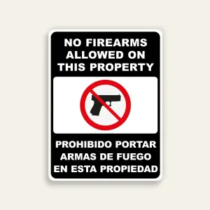 Full black 18x24 vertical Maxmetal sign with bold white English text No Firearms Allowed On This Property at top, white-bordered inset with red circle-slash over handgun icon in center, and Spanish text Prohibido Portar Armas De Fuego En Esta Propiedad in white at bottom.