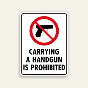 White 18x24 vertical Maxmetal sign with large red circle-slash over handgun silhouette in upper half and bold black uppercase text Carrying A Handgun Is Prohibited in lower half on clean white background.