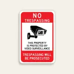 Full red 12x18 vertical Maxmetal sign with bold white NO TRESPASSING in upper red zone, large white inset panel with oversized front-facing CCTV camera illustration and black text This Property Is Protected By Video Surveillance, and bold white TRESPASSING WILL BE PROSECUTED on red lower panel.