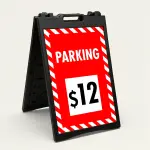 Custom red and white hazard stripe parking rate A-frame sign with large white rate display box showing dollar amount for Los Angeles parking lot or event venue
