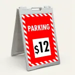 Custom red and white hazard stripe parking rate A-frame sign with large white rate display box showing dollar amount for Los Angeles parking lot or event venue