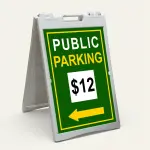 Custom green and yellow parking rate directional A-frame sign with white rate display box and yellow arrow for Los Angeles parking lot or event venue