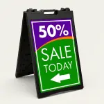 Custom purple and green sale percentage directional A-frame sign with large discount percentage bold sale message and directional arrow for Los Angeles retail store boutique or pop-up vendor