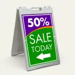 Custom purple and green sale percentage directional A-frame sign with large discount percentage bold sale message and directional arrow for Los Angeles retail store boutique or pop-up vendor