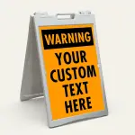 Custom orange and black warning A-frame sign with bold WARNING header and custom text zone for Los Angeles construction site parking lot or commercial facility