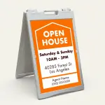 Custom orange and white open house date and address A-frame sign with house icon open house text date hours property address and agent contact zone for Los Angeles real estate listing