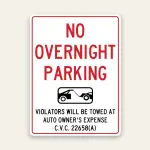 White No Overnight Parking sign with bold red text, black tow truck icon in center, and C.V.C. 22658A tow-away warning below.