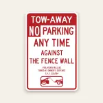 Red and white Tow-Away No Parking Any Time Against the Fence Wall sign with tow-away warning, C.V.C. 22658A citation, and tow truck icon.