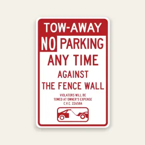 Red and white Tow-Away No Parking Any Time Against the Fence Wall sign with tow-away warning, C.V.C. 22658A citation, and tow truck icon.