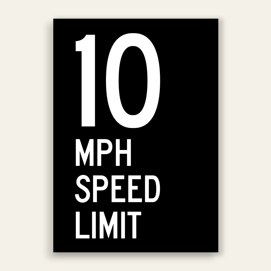 Black and white 10 MPH Speed Limit sign with oversized white number 10 and MPH SPEED LIMIT text below on full black panel.