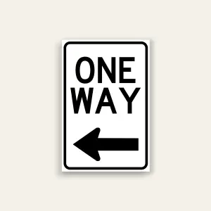 Black and white One Way sign with bold ONE WAY text and full-width left-pointing arrow below, rounded black border.