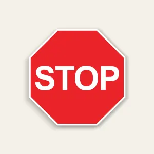 Red octagon stop sign with white border and bold white STOP text centered on the panel.