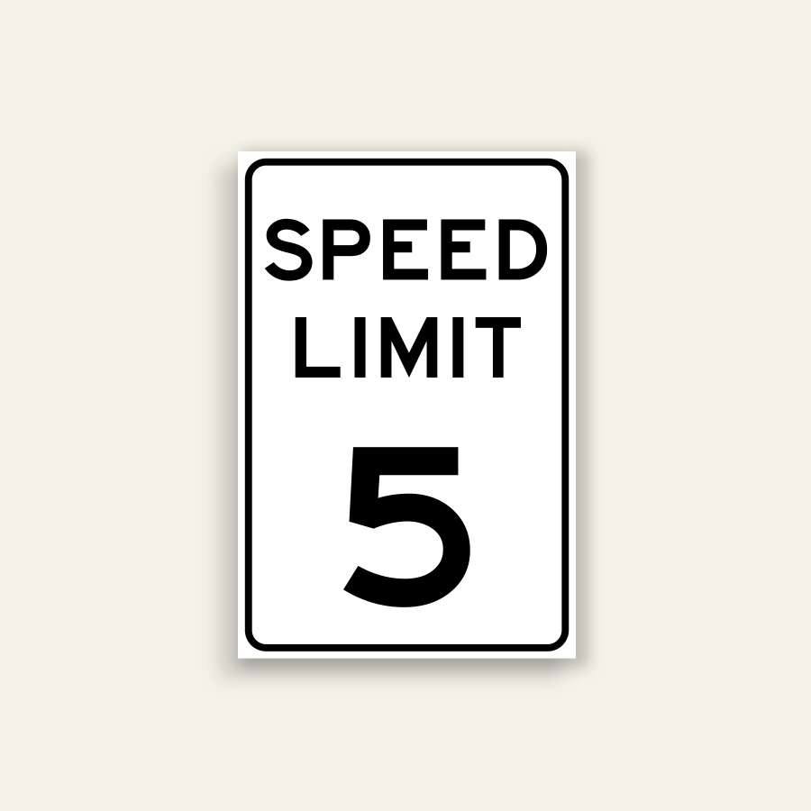 White portrait speed limit sign with rounded black border and black text reading SPEED LIMIT above a large numeral 5.