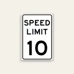 White portrait speed limit sign with rounded black border and black text reading SPEED LIMIT above a large numeral 10.
