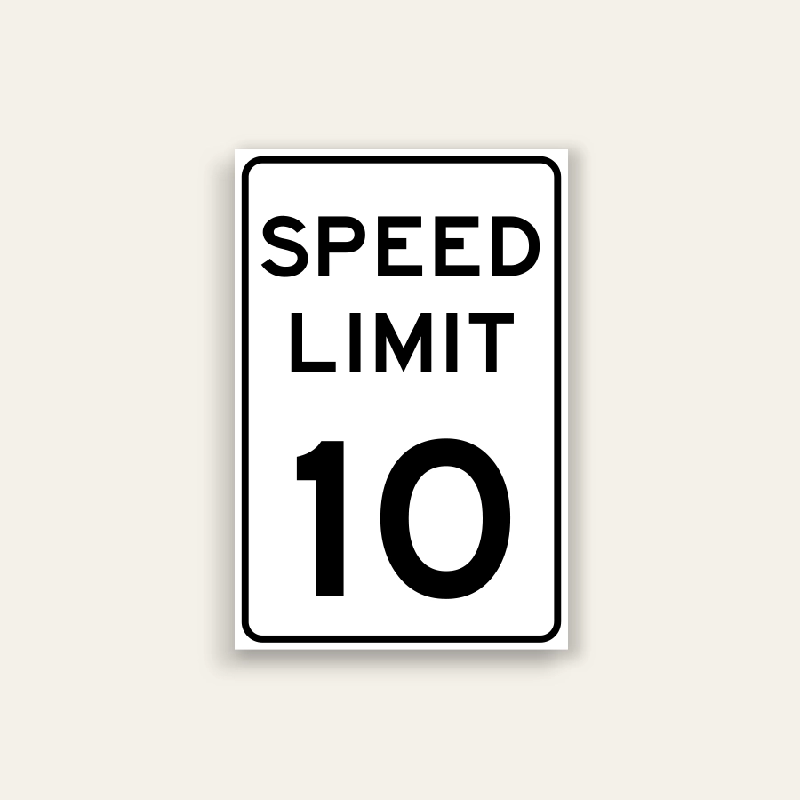 White portrait speed limit sign with rounded black border and black text reading SPEED LIMIT above a large numeral 10.