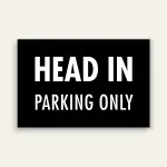 Black landscape sign with bold white text reading HEAD IN above smaller PARKING ONLY text, no border.