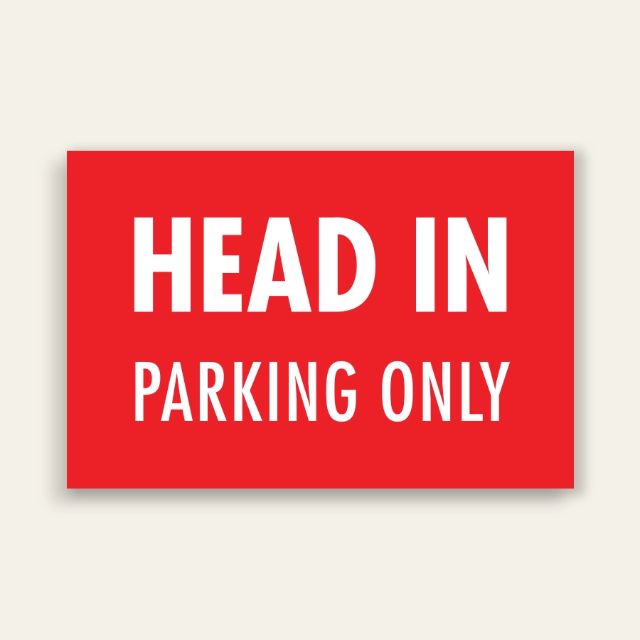 Red landscape sign with bold white text reading HEAD IN above smaller PARKING ONLY text, no border.