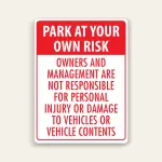 Red and white portrait sign with red header reading PARK AT YOUR OWN RISK above red text stating owners and management are not responsible for personal injury or damage to vehicles or vehicle contents.