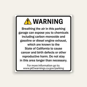 White square warning sign with black border, yellow warning triangle icon and black WARNING header above Proposition 65 text about carbon monoxide and engine exhaust exposure in parking garages, with reference URL at bottom.